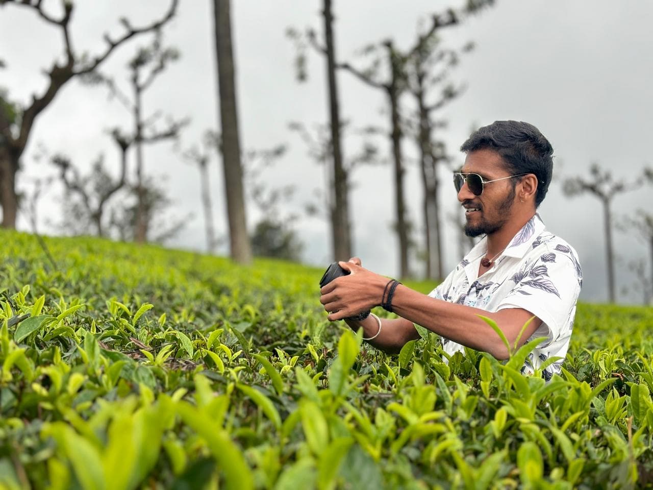 Traveller photographing the tea gardens near Ooty