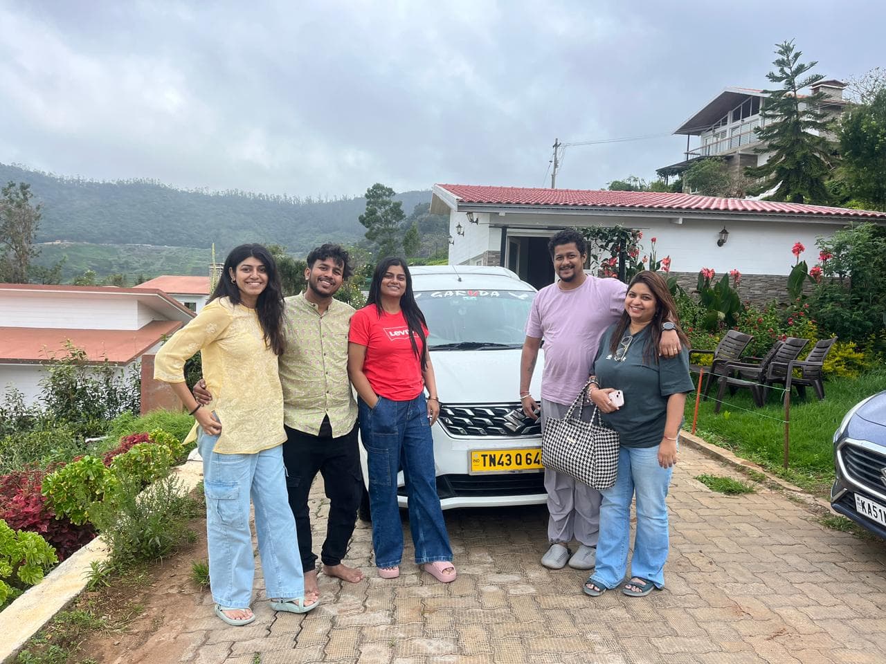 Family group with their Garuda Travels cab at an Ooty viewpoint