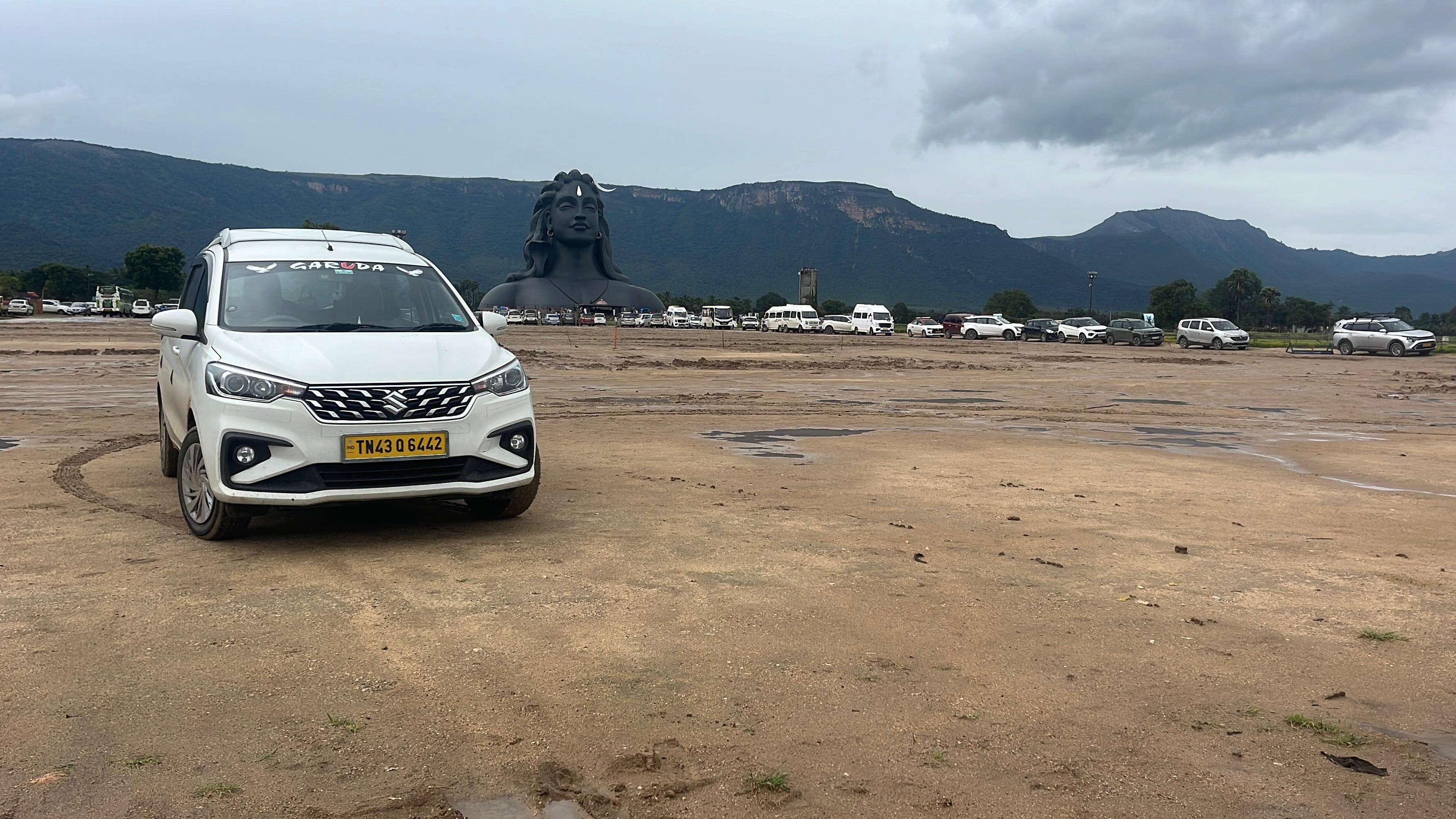 Cab parked on open ground with the Nilgiri hills behind